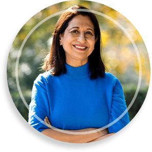 Confident senior woman with arms crossed at park