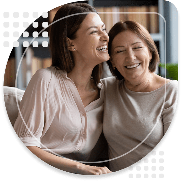 Happy senior mother and grownup daughter sit relax on couch
