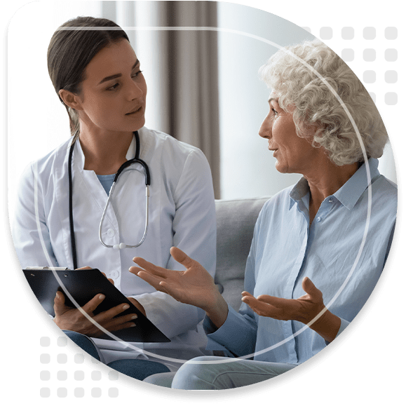 Senior woman takes a doctor at home telling about health complaints nurse writing personal information fill form attentively listens elderly patient. Healthcare, geriatric medicine, medical check-up