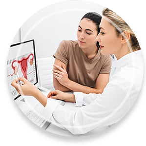 gynecologist communicates with her patient, indicating the menstrual cycle on the monitor. The reproductive specialist calculated the period of ovulation for the patient
