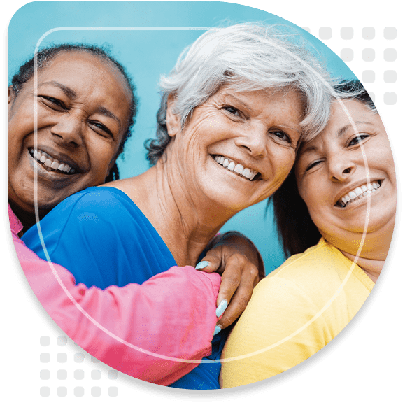 Happy diverse senior people hugging each other outdoor - Older friends community concept - Focus on center woman face